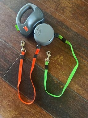 Two Retractable Dog Leashes with Orange and Neon Green Straps
